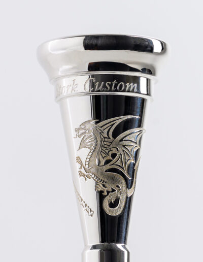 “Dragon” Mouthpiece Engraving This design is suitable for all french horn models, all trombone models and for trumpet shanks (without the bars). The cost is $40. With the tribal bars (not available for trumpets, cornets or flugelhorn pieces) the cost is $50.